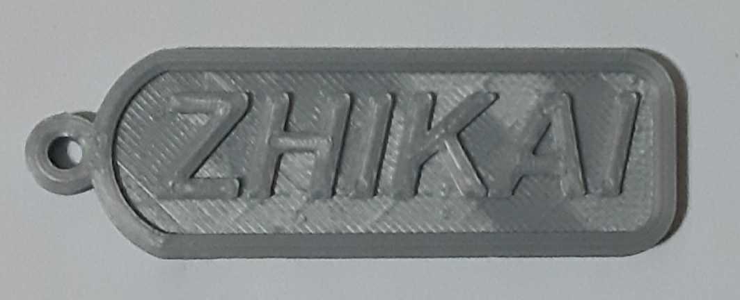 A 3D printed nametag with a name on it